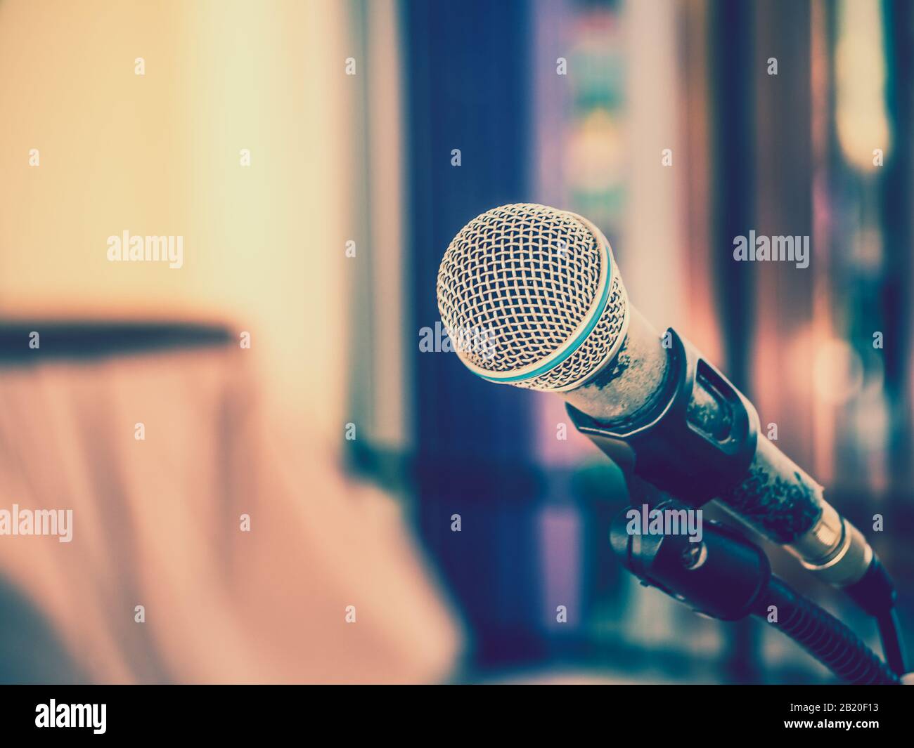 Close up of microphone on abstract blurred background for speech in seminar room or communication and speaking conference hall, Background concept. Stock Photo