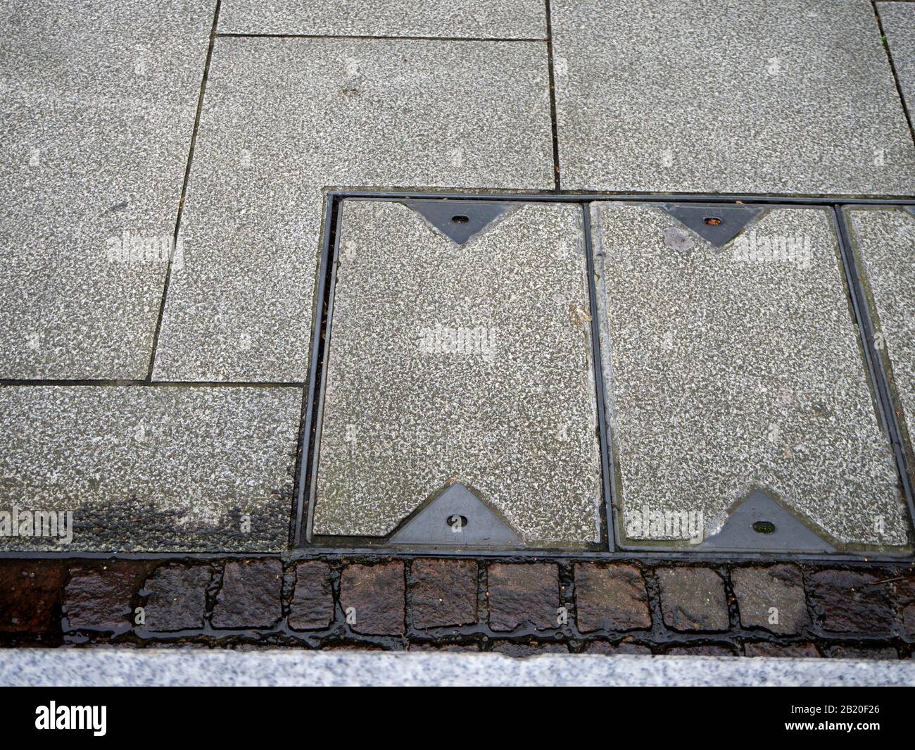 Telephone cable junction box cover in pavement Stock Photo Alamy