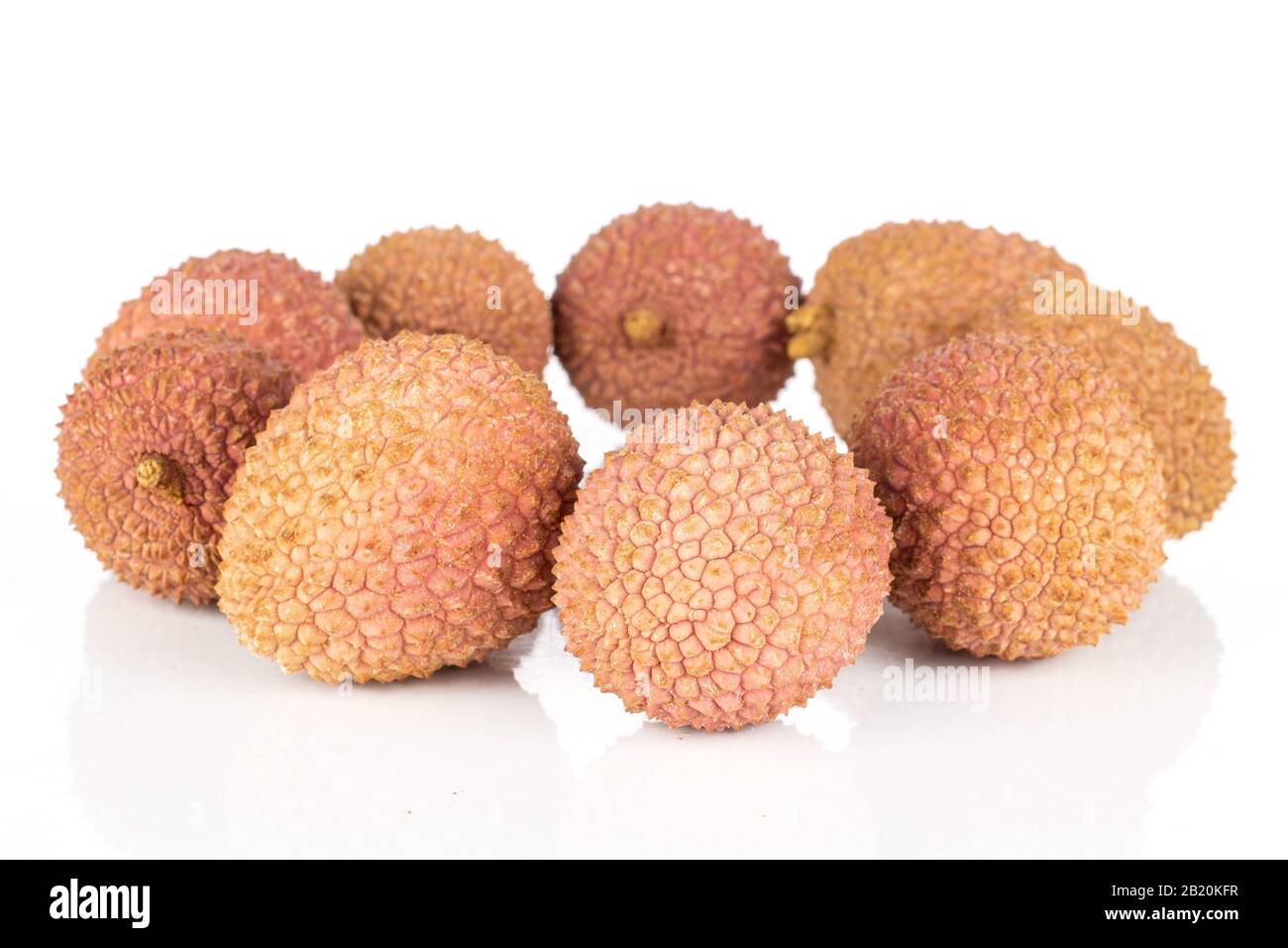 Group of eight whole fresh lychee circle isolated on white background