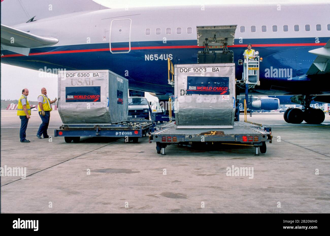 Baggage handlers (fleet service clerks) loading an airplane Stock Photo