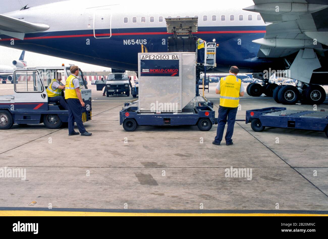 Baggage handlers (fleet service clerks) loading an airplane Stock Photo