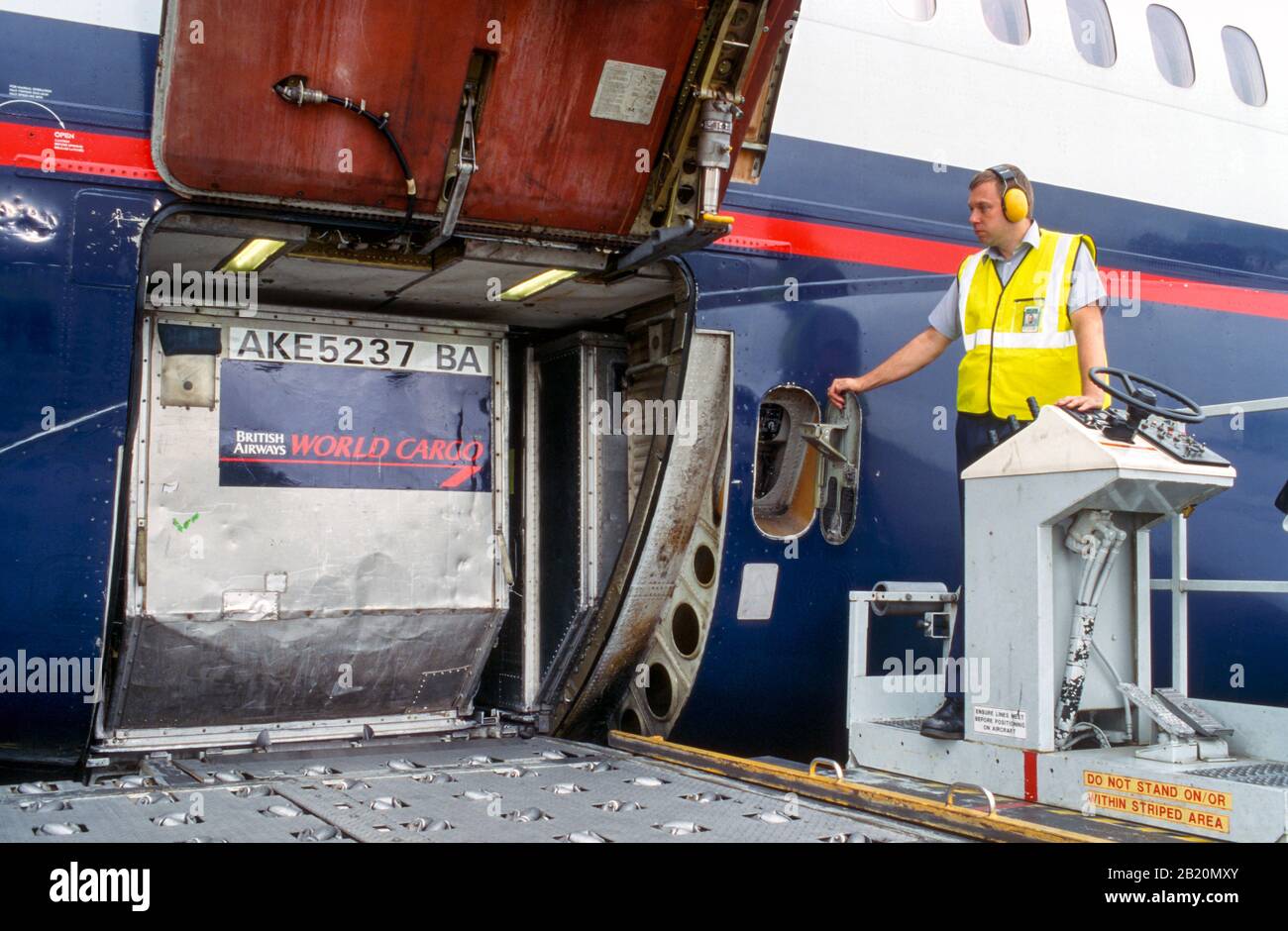 Baggage handlers (fleet service clerks) loading an airplane Stock Photo