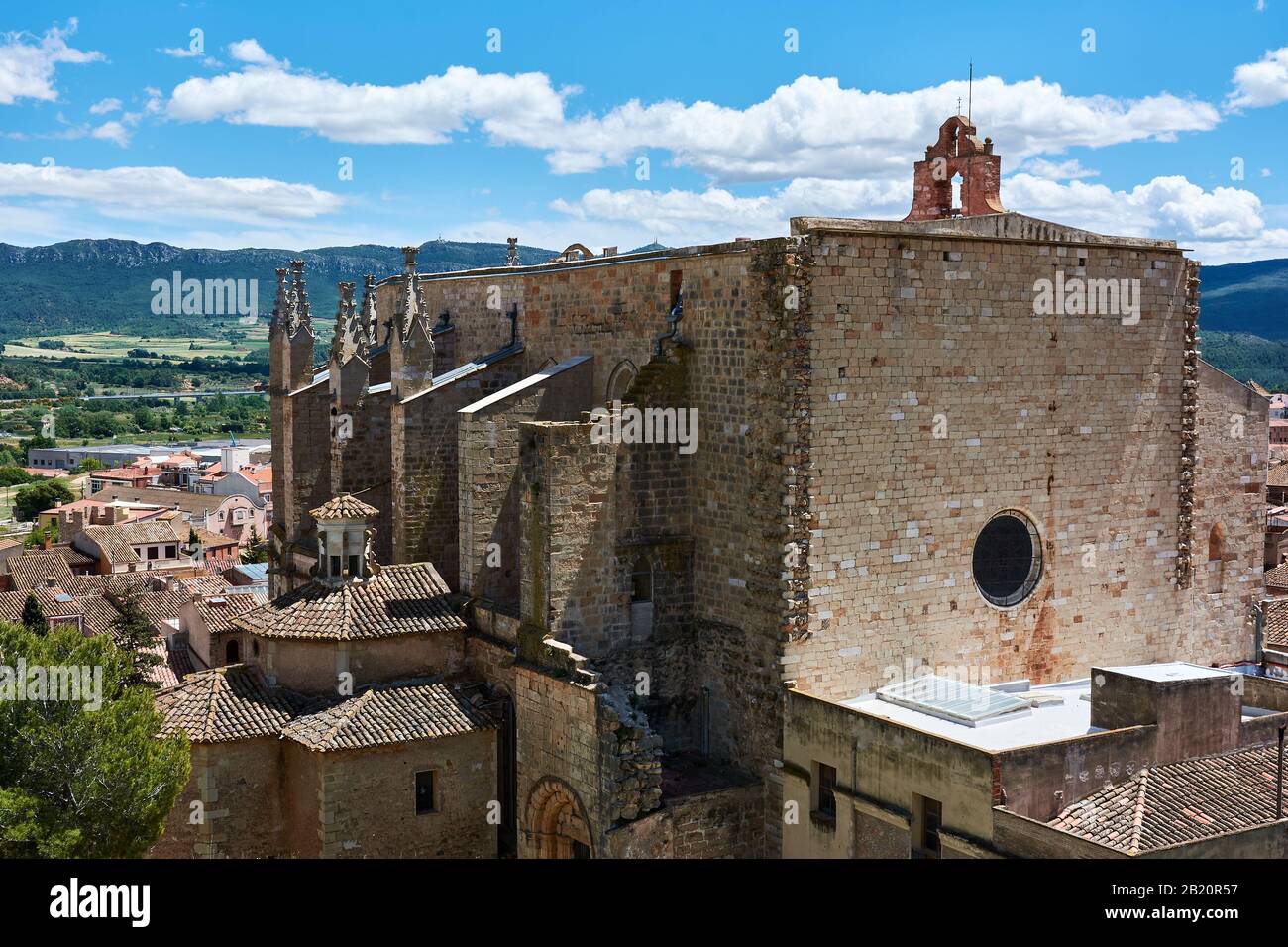 View of the gothic church of Saint Mary in the medieval village of Montblanc, province of Tarragona, Spain. Amazing landscape of mountains behind. Stock Photo