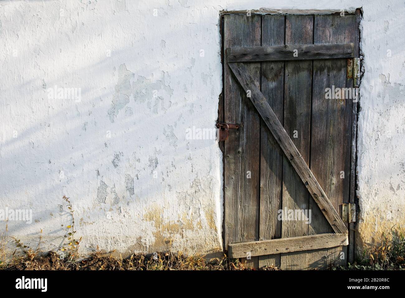 Old wooden door in an old stone wall with a castle Stock Photo - Alamy