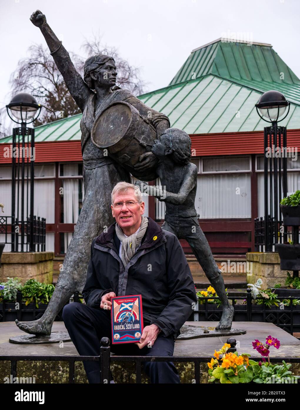 Tranent, East Lothian, Scotland, United Kingdom, 28th February 2020. Kenny MacAskill, recently elected SNP Member of Parliament for East Lothian, publishes a new book on February 27th 2020 (Biteback Publishing) called 'Radical Scotland'. One chapter describes the Tranent Massacre in 1797 in which Jackie Crookston, featured in the sculpture by David Annand behind him, was killed Stock Photo