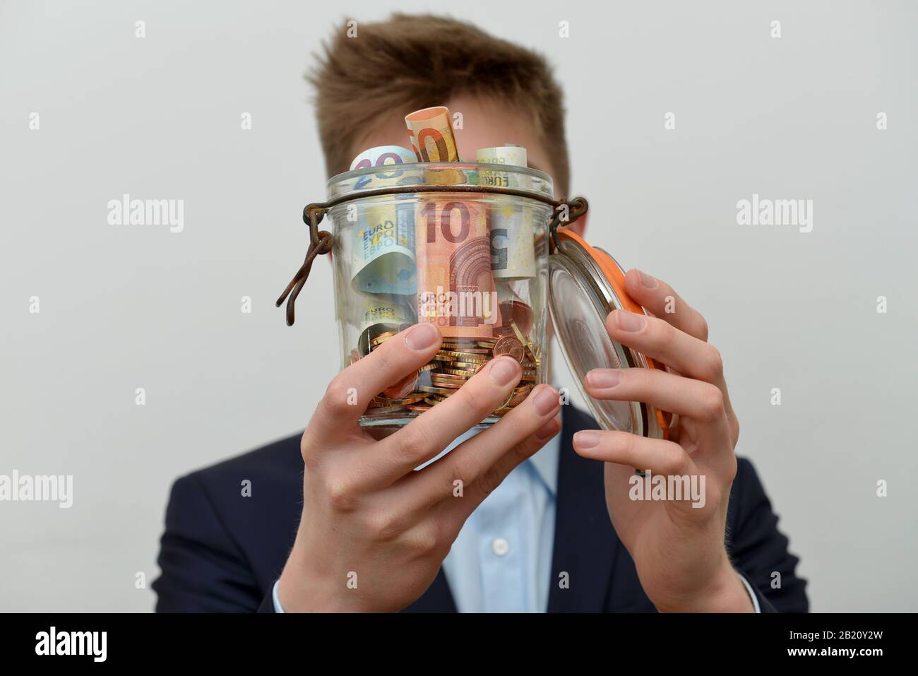 Mann, Sparbuechse Stock Photo