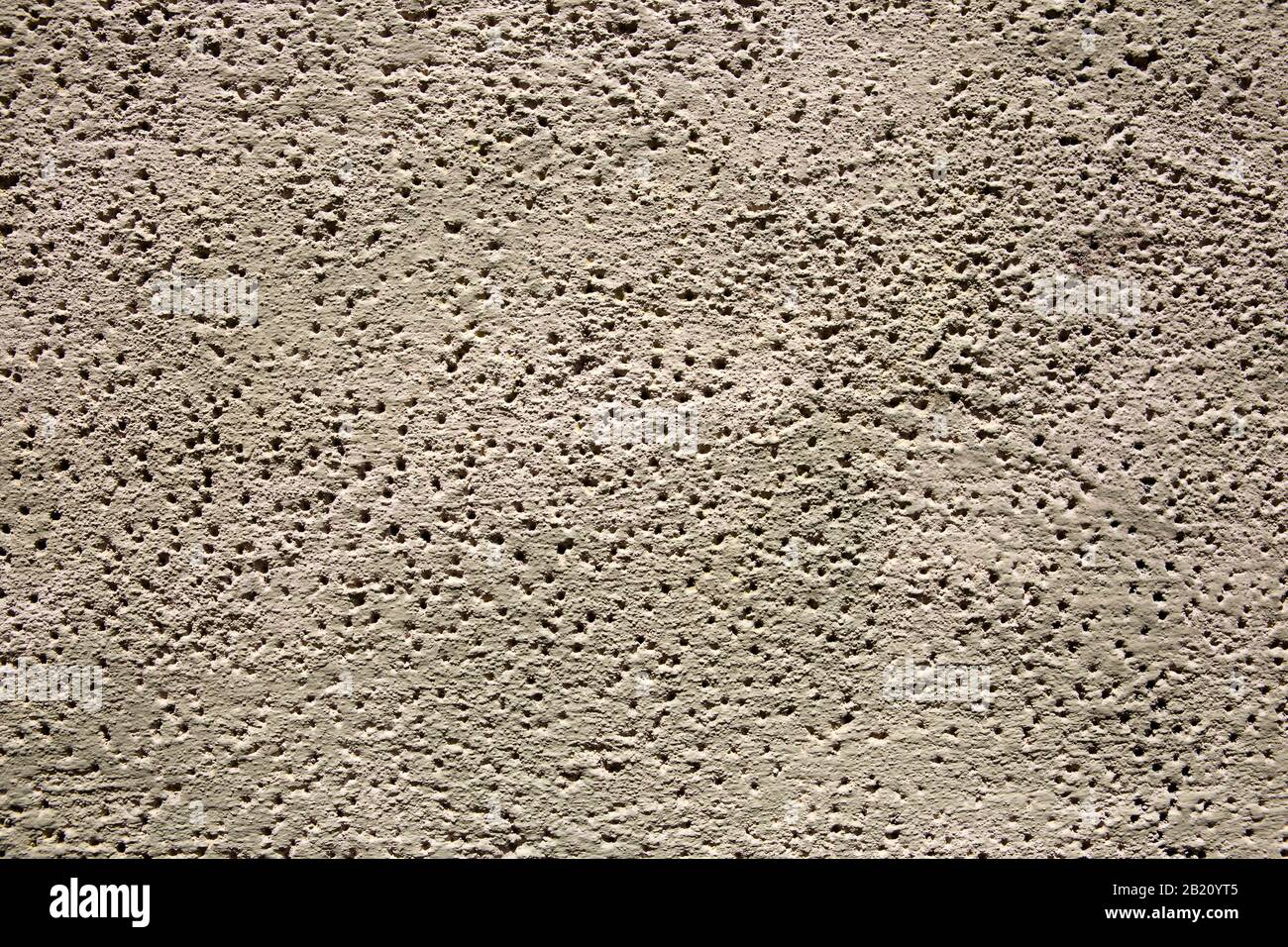 backgrounds of cement wall full of holes Stock Photo