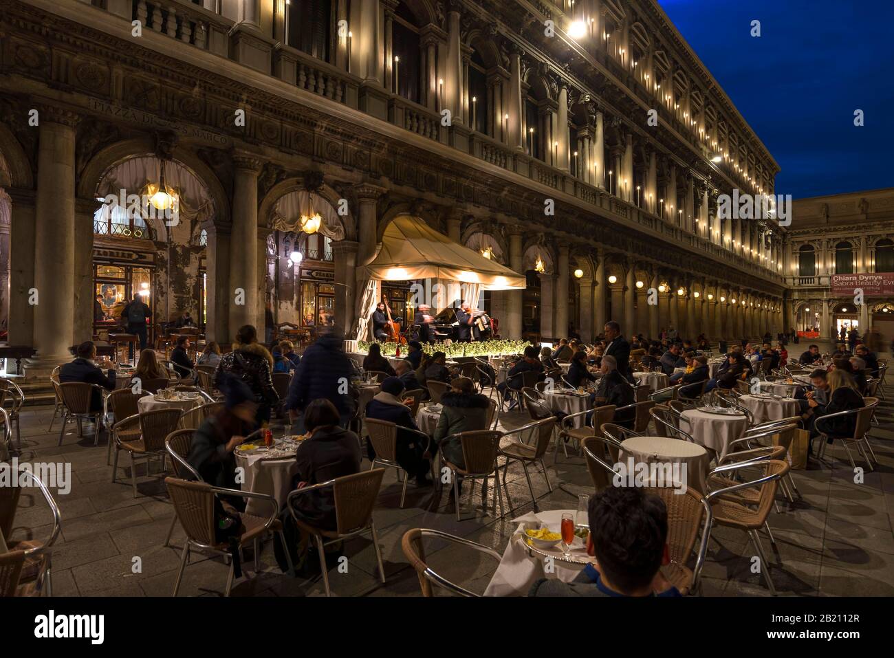 Playing music orchestra in front of the historic Cafe Florian on St. Mark's Square in the evening, Venice, Veneto, Italy Stock Photo