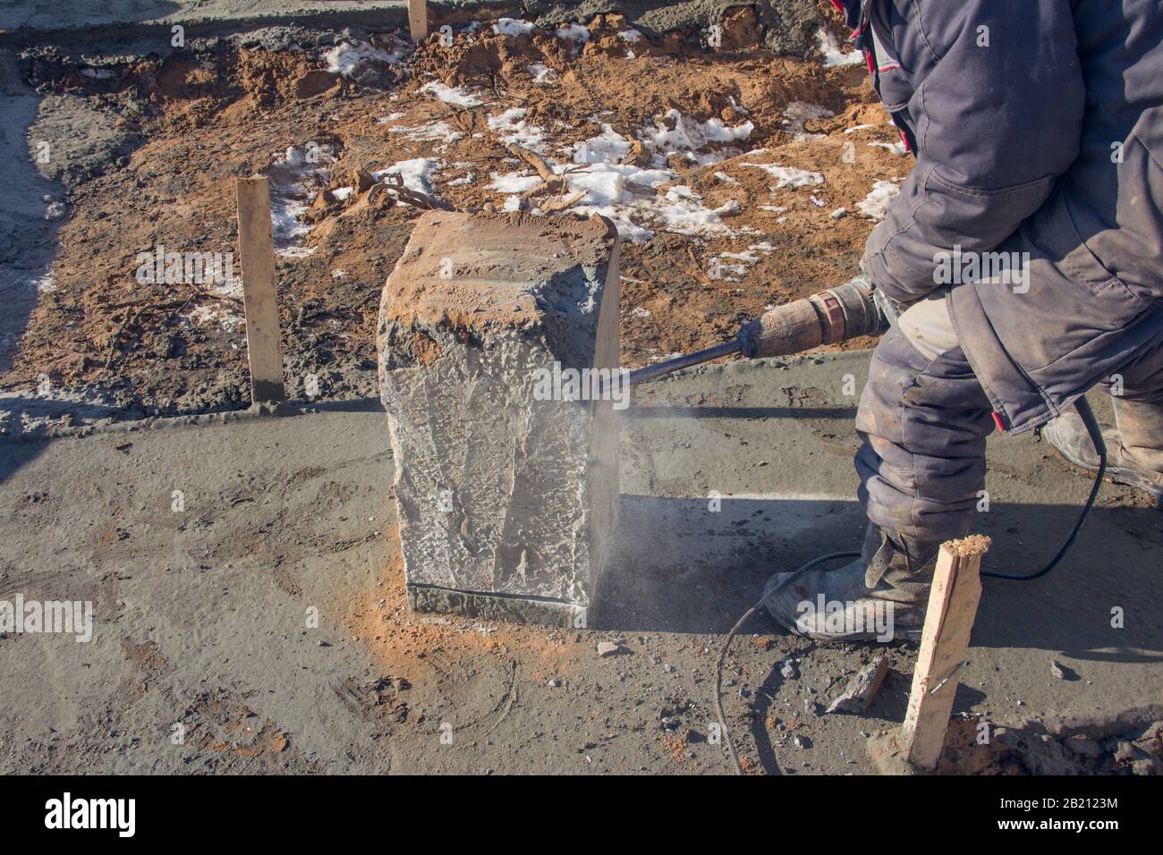 Electric jackhammer for demolition work. Professional worker at a