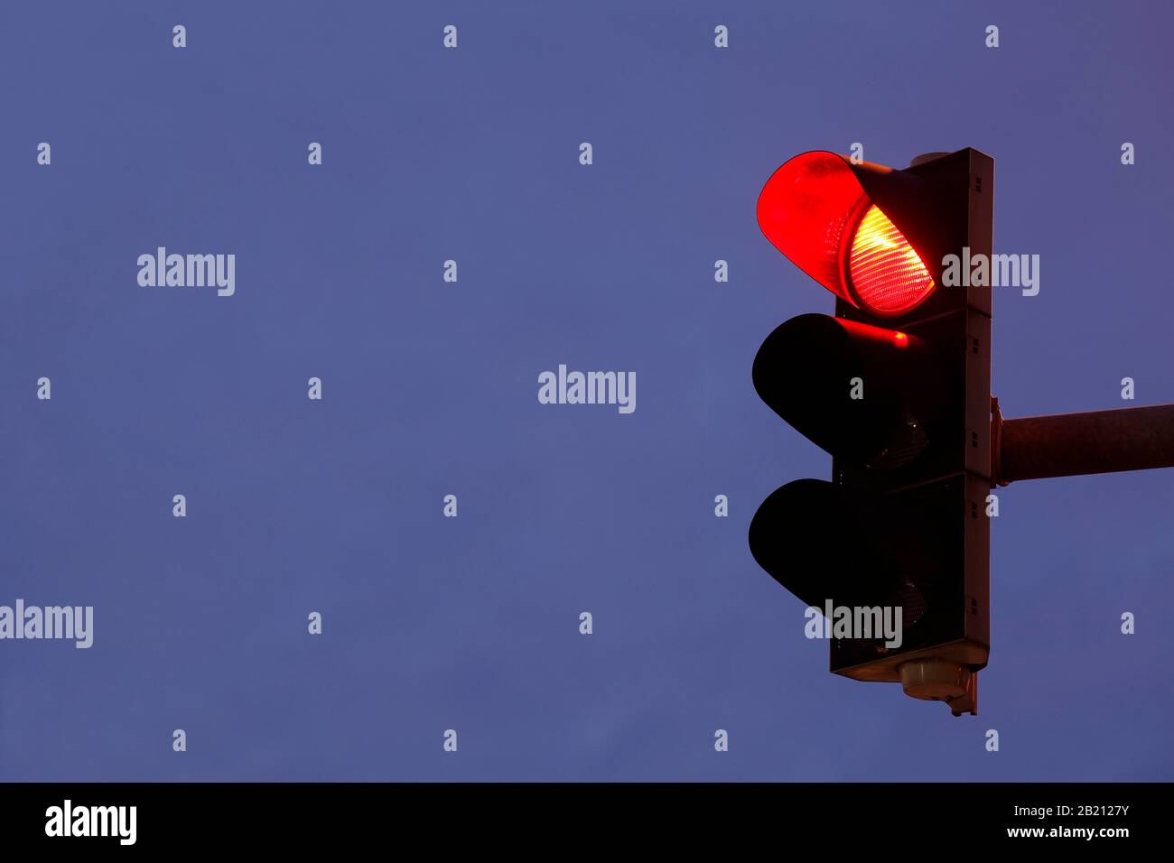 Traffic light shows red at dusk, Germany Stock Photo - Alamy