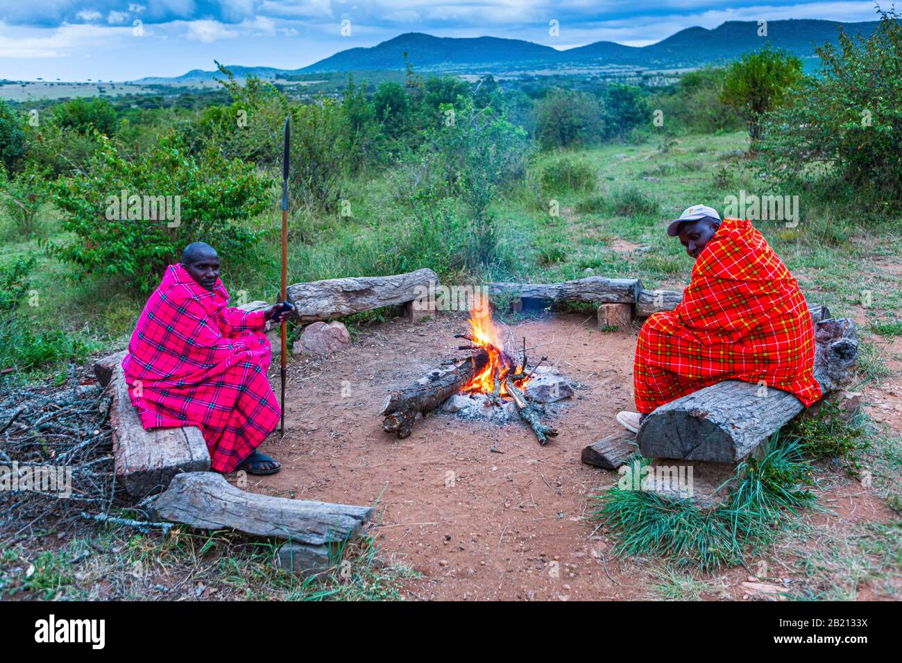 Maasai men around a campfire, Masai Mara National Park, Kenya Stock Photo