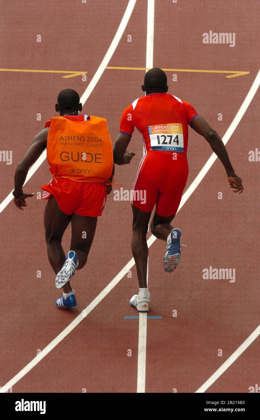 Athens, Greece  21SEP04: Blind runners competing with the help of sighted guides in the 100-meter preliminaries at the Athens Paralympics. ©Bob Daemmrich Stock Photo