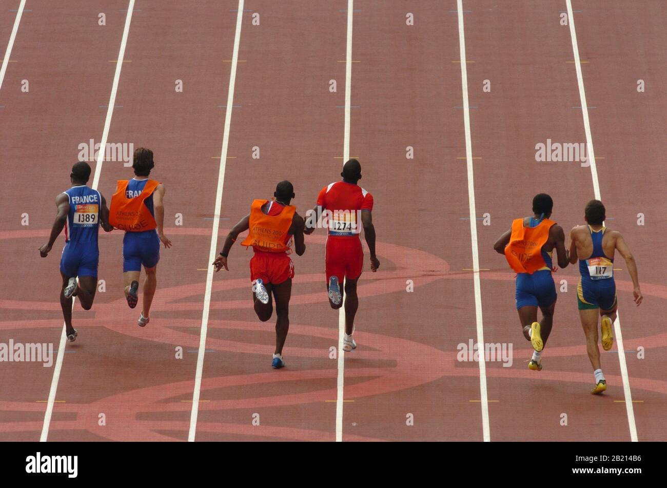 Athens, Greece  21SEP04: Blind runners competing with the help of sighted guides in the 100-meter preliminaries at the Athens Paralympics. ©Bob Daemmrich Stock Photo