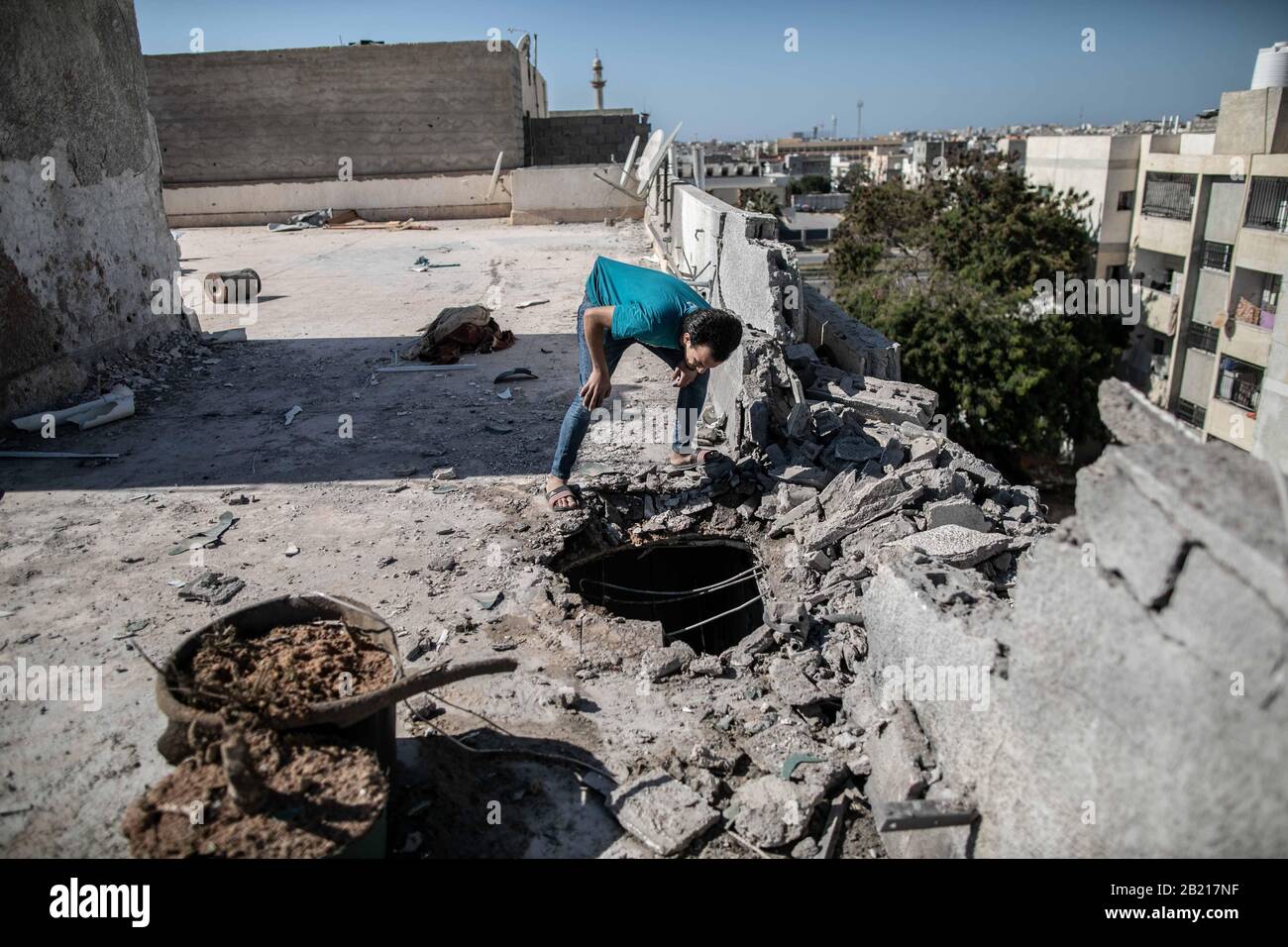Tripoli, Libya. 28th Feb, 2020. A man inspects the damage in a building after a heavy shelling attack in Tripoli, Libya, on Feb. 28, 2020. The forces of the UN-backed Libyan government said on Friday that the rival east-based army attacked the Mitiga International Airport and its surroundings, as well as a number of residential neighborhoods, in Tripoli with heavy shelling. Credit: Amru Salahuddien/Xinhua/Alamy Live News Stock Photo