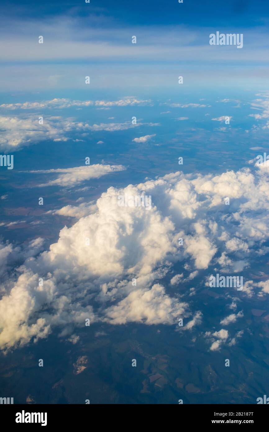 Aerial view of Hungary’s Northern Great Plain region under white clouds from flying plane Stock Photo
