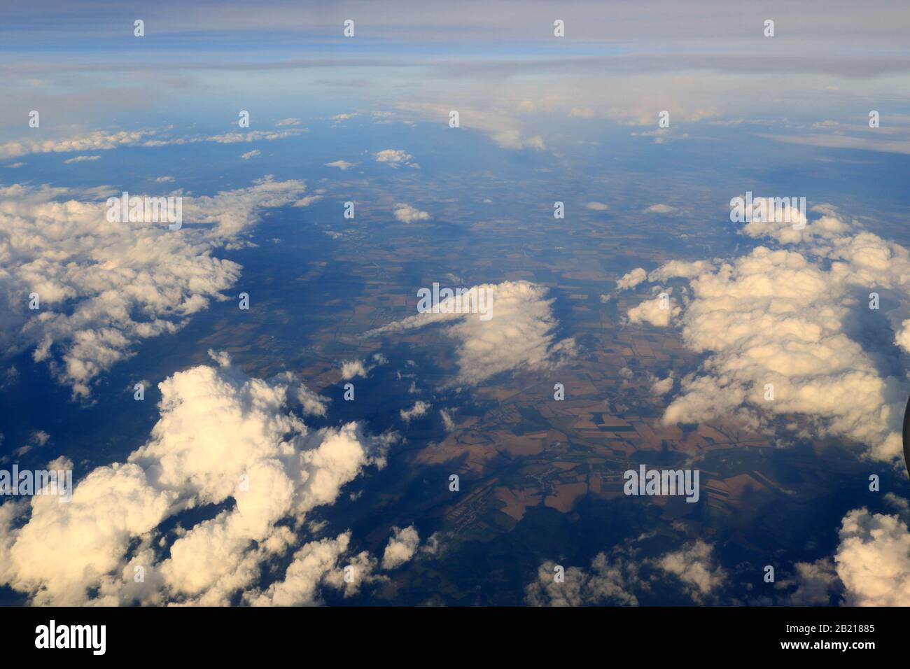 Aerial view of Hungary’s Northern Great Plain region under white clouds from flying plane over the Romanian-Hungarian border Stock Photo