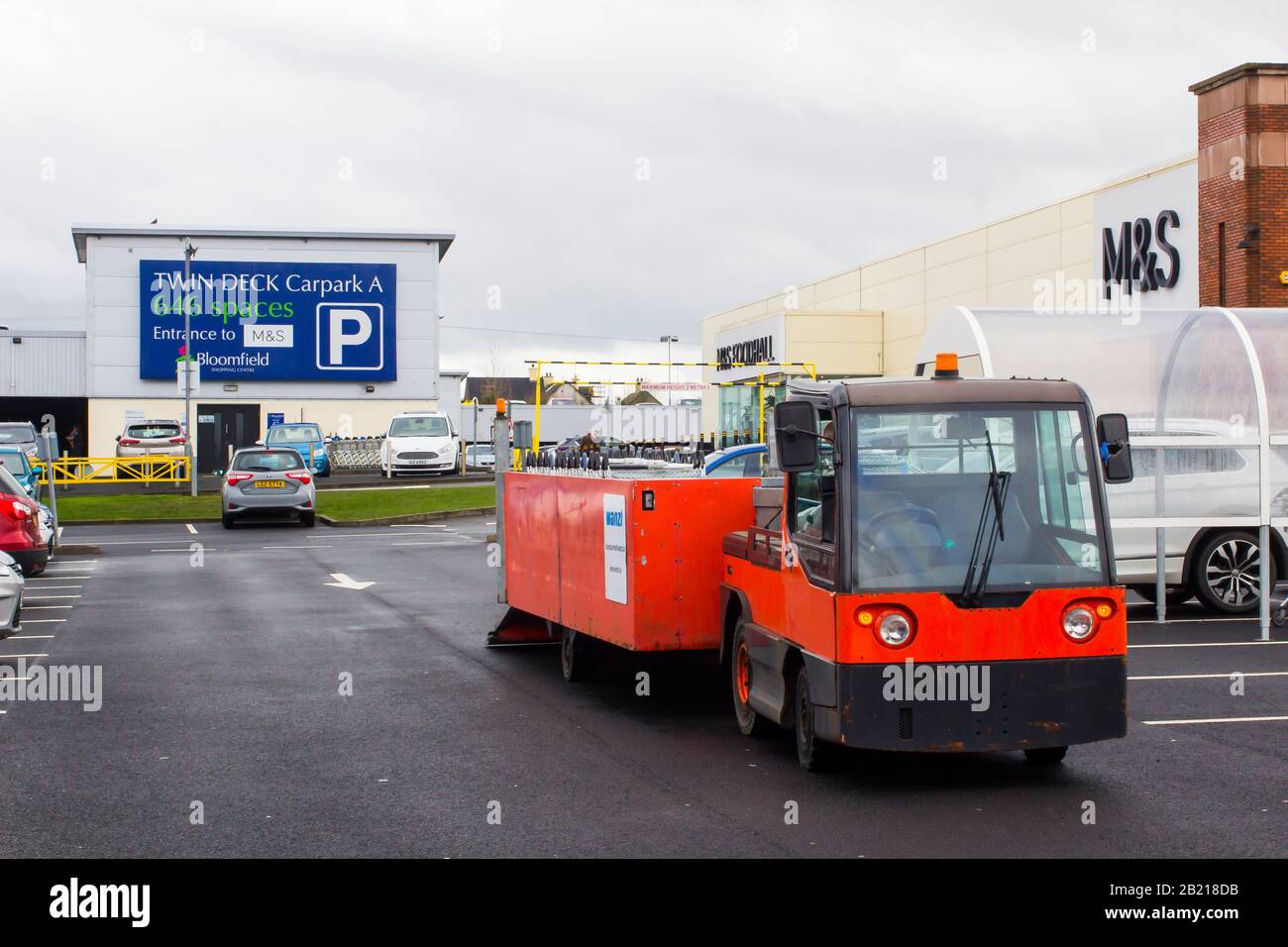 28 February 2020 A battery powered Wanzi shopping trolley recovery vehicle at work outside Marks and Spencer in the Bloomfield Shopping Centre Carpark Stock Photo