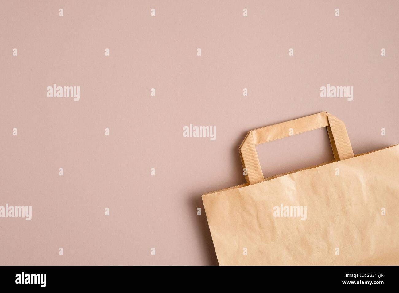 Empty kraft paper bag on brown background with copy space. Packaging template mockup Stock Photo