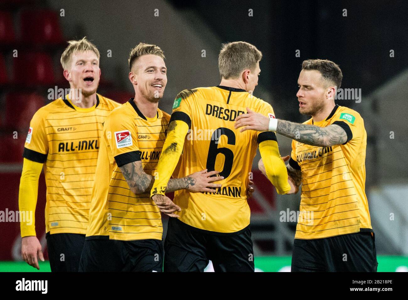 28 February 2020, Bavaria, Regensburg: Football: 2nd Bundesliga, Jahn Regensburg - Dynamo Dresden, 24th matchday in the Continental Arena. Simon Makienok Christoffersen (l-r), Ondrej Petrak, Marco Hartmann and Patrick Schmidt from Dynamo Dresden cheer for their victory after the final whistle. Photo: Matthias Balk/dpa - IMPORTANT NOTE: In accordance with the regulations of the DFL Deutsche Fußball Liga and the DFB Deutscher Fußball-Bund, it is prohibited to exploit or have exploited in the stadium and/or from the game taken photographs in the form of sequence images and/or video-like photo ser Stock Photo