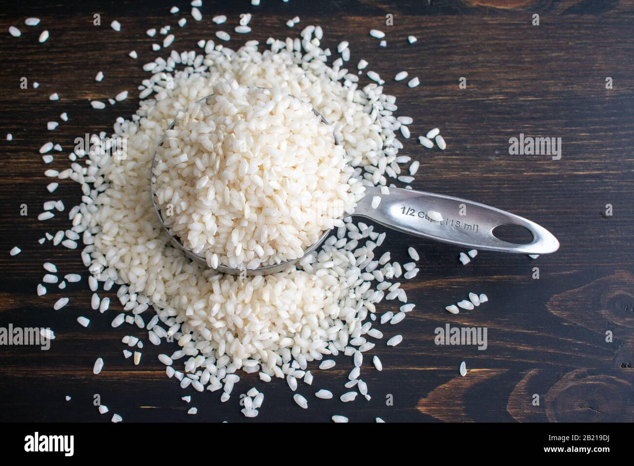 Arborio Rice in a Measuring Cup Raw shortgrain rice in a measuring