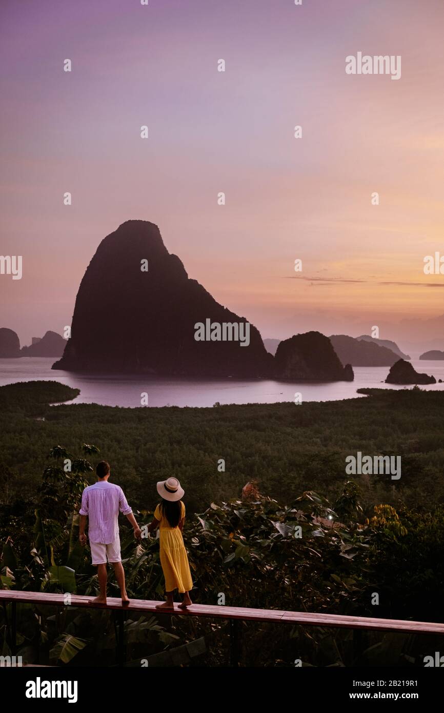 Phangnga Bay during sunrise, couple watching sunrise at the viewpoint Samet Nang Shee Thailand Phangnga province Stock Photo