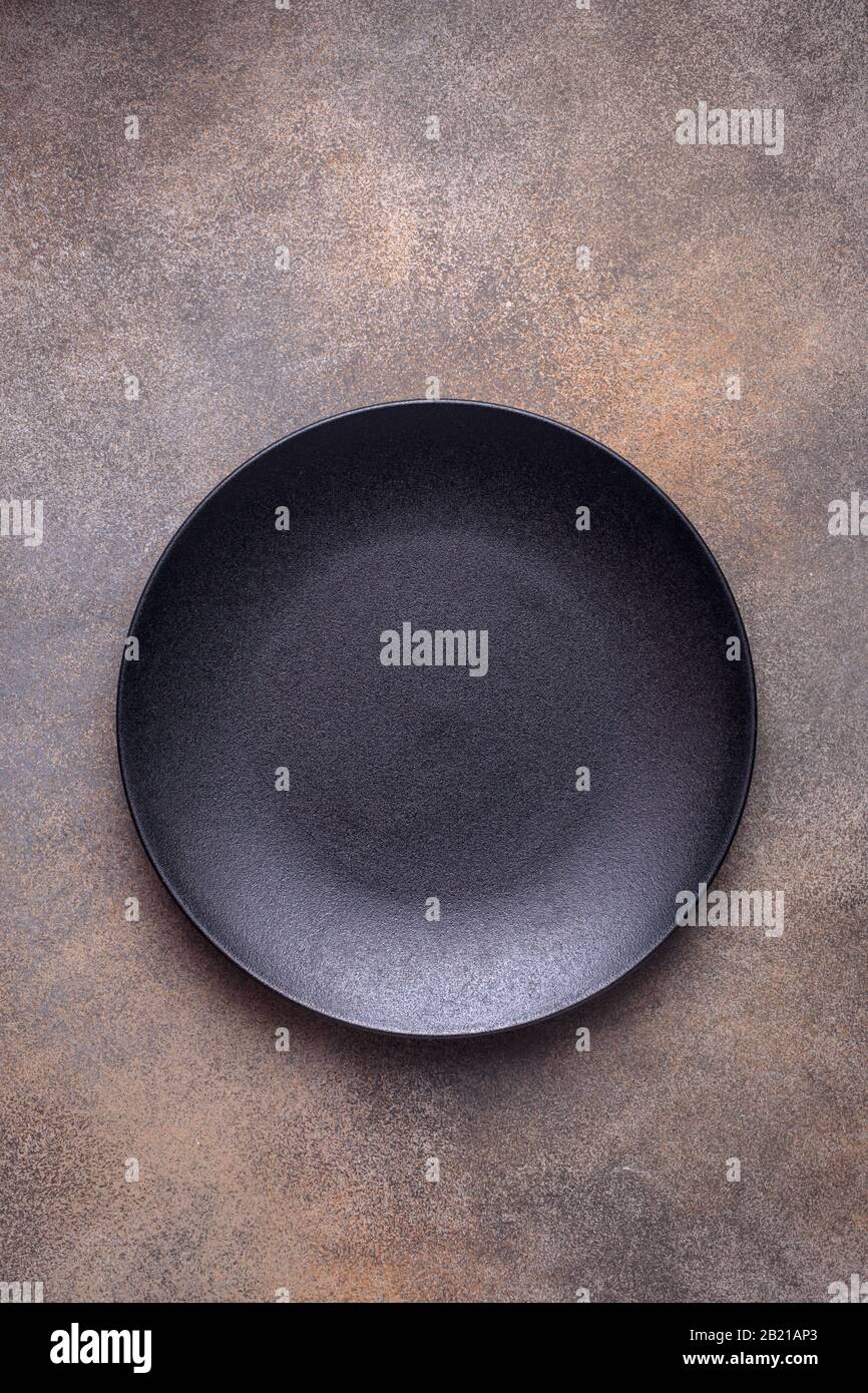 Empty black plate on brown Stock Photo