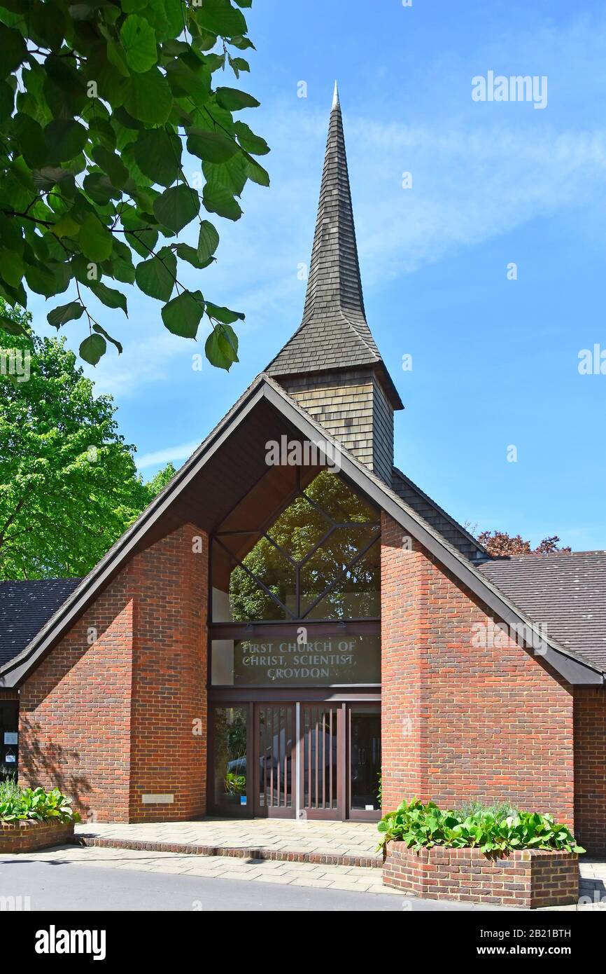 Modern front facade & shingle clad spire tower First Church of Christ Scientist modern entrance in brick building at Croydon South London England UK Stock Photo