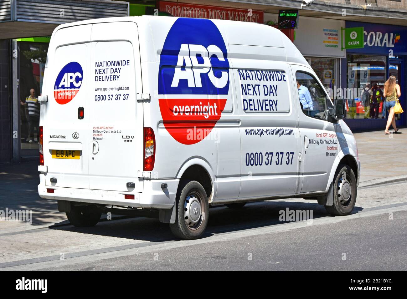 Back & side street view of APC Overnight van making drop off in town centre part of an independent parcel delivery network business London England UK Stock Photo