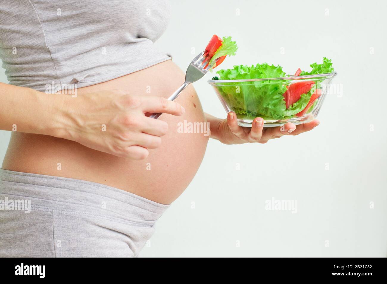 healthy nutrition and pregnancy. pregnant woman's belly and vegetable