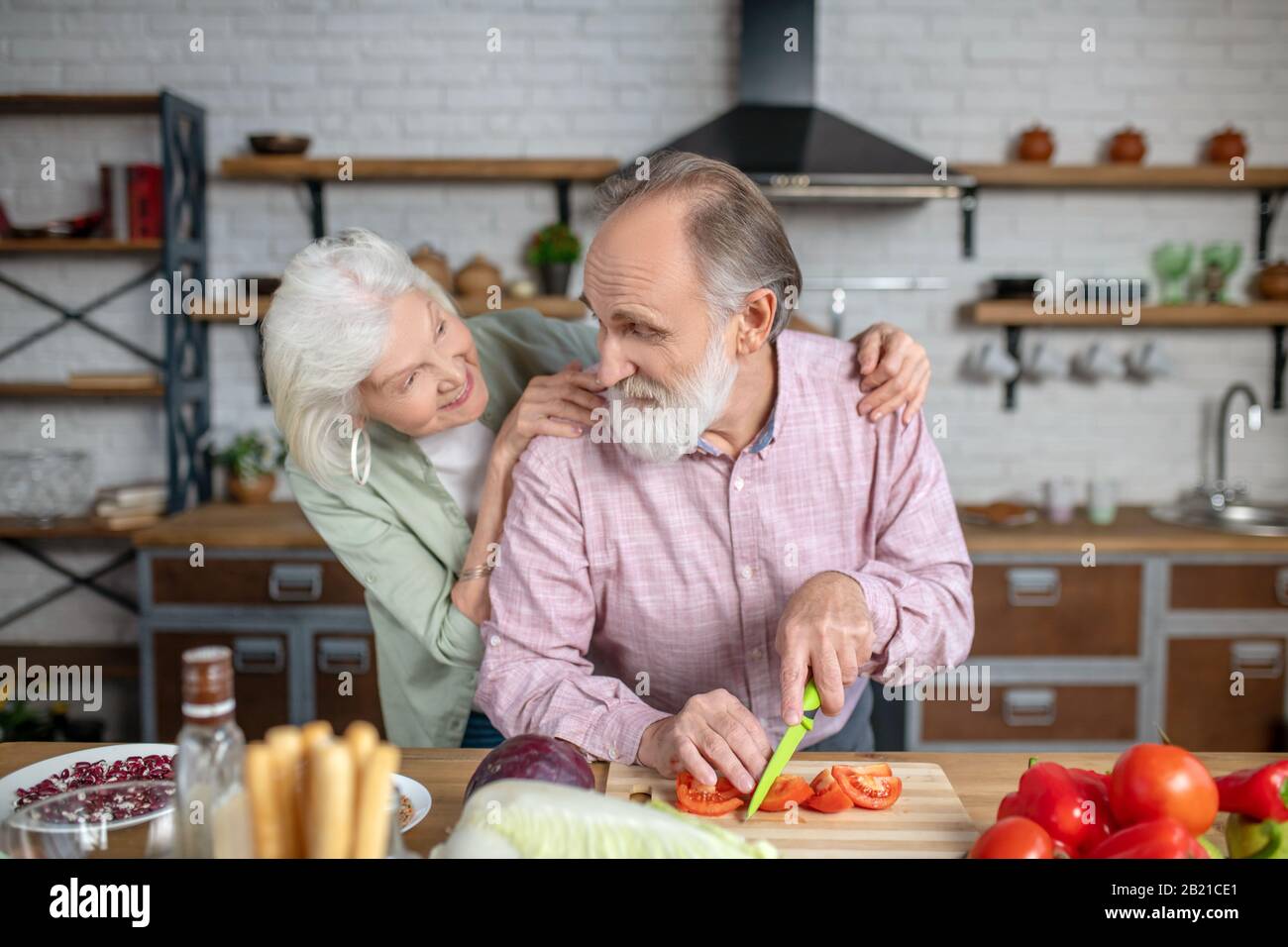 Elderly man and woman preparing a healthy meal for a dinner Stock Photo
