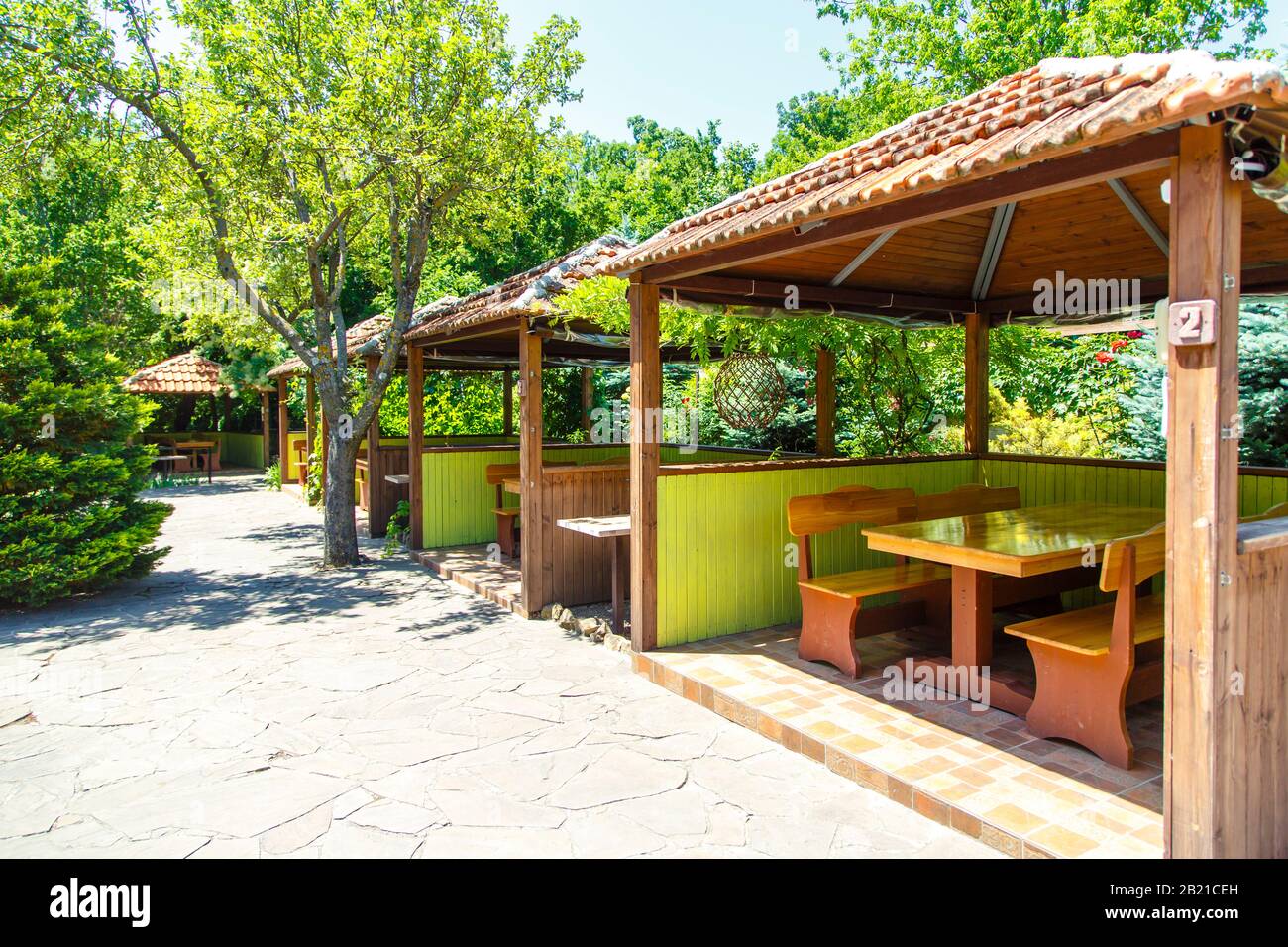 Wooden Gazebos in a summer cafe in the spring. Spring greenery and