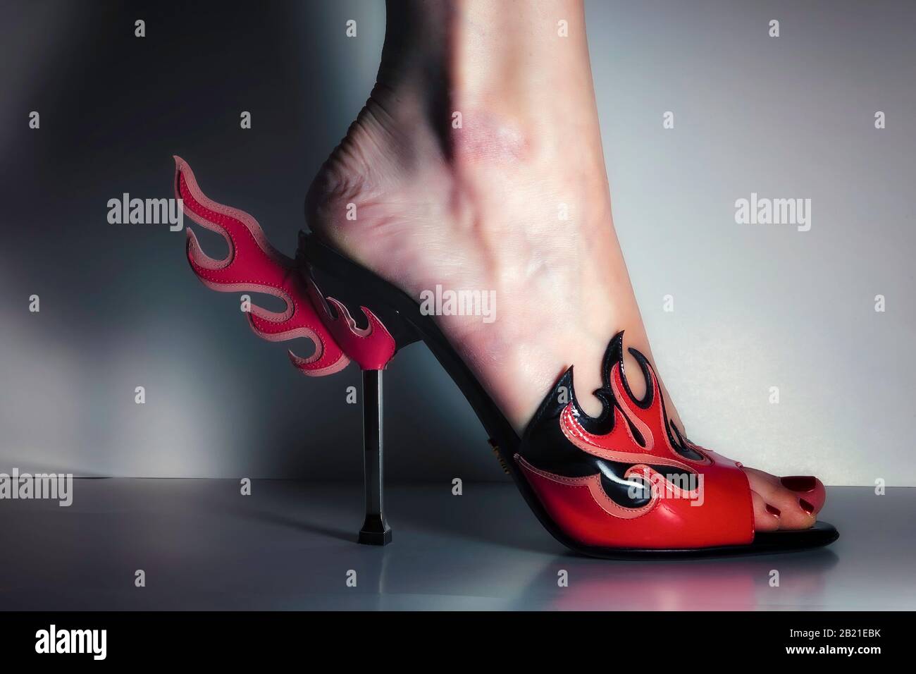 Prada flame high heel shoes with woman's foot, side view, color Stock Photo  - Alamy