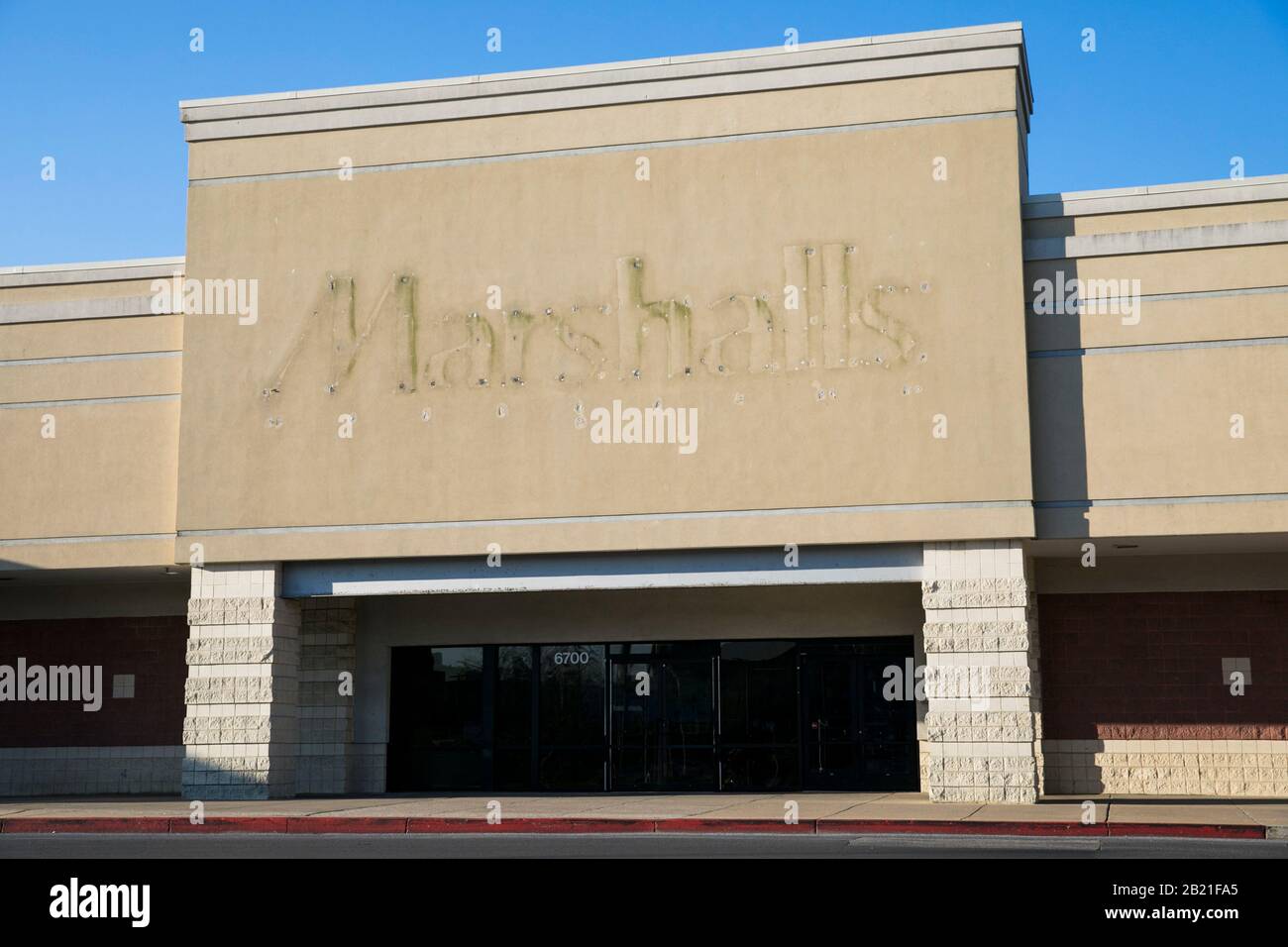 The faded outline of a Marshalls logo sign outside of a closed retail