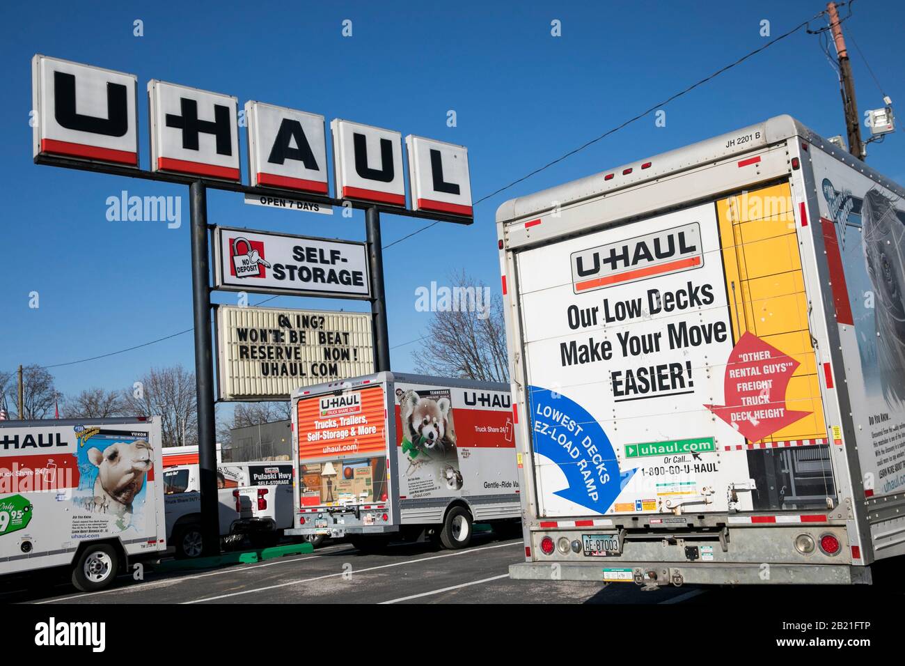 A logo sign and moving trucks outside of a U-Haul location in Baltimore, Maryland on February 22, 2020. Stock Photo