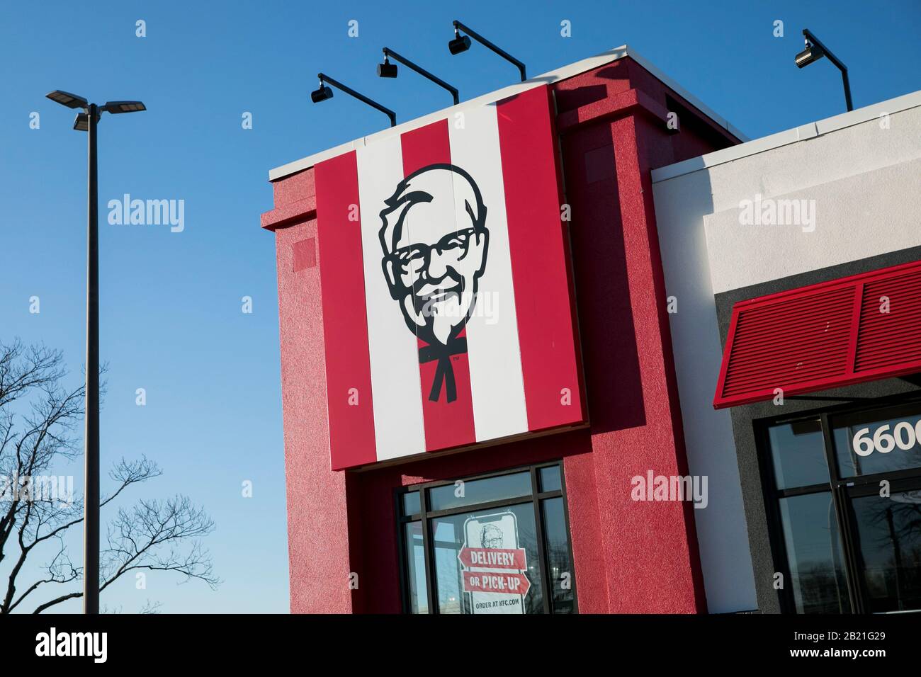 A logo sign outside of a Kentucky Fried Chicken (KFC) fast food restaurant location in Baltimore, Maryland on February 21, 2020. Stock Photo