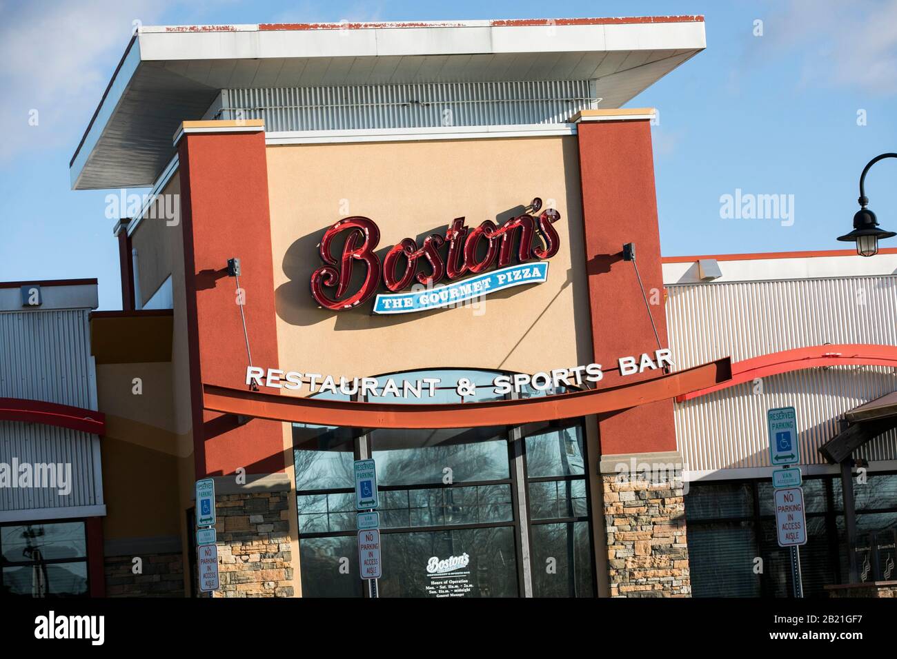A logo sign outside of a Boston Pizza, Boston's The Gourmet Pizza