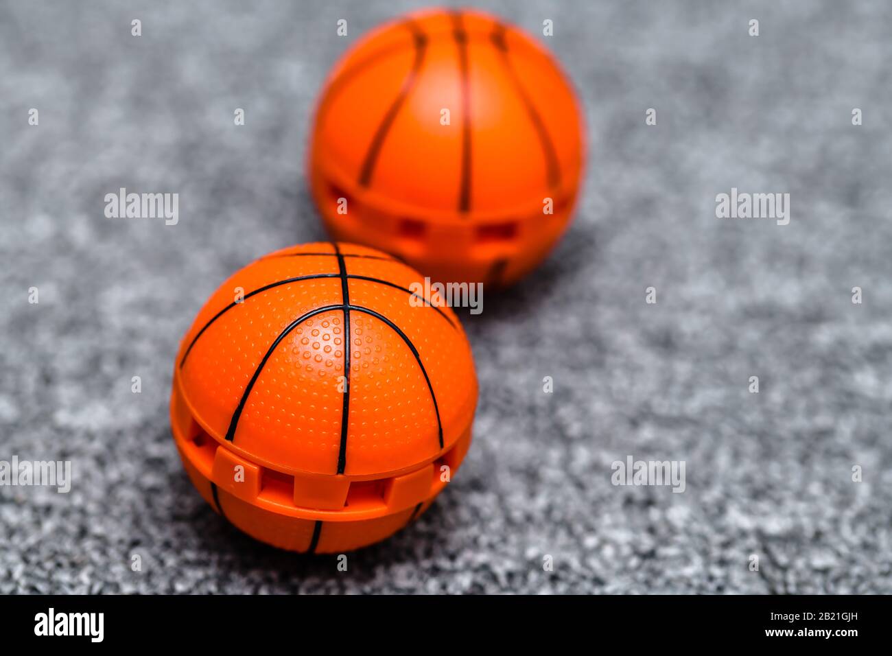 Two orange basket ball like shoe freshener balls.Concept for avoiding