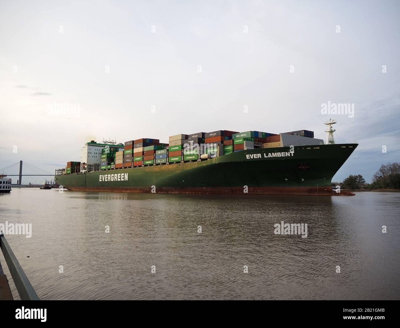 SAVANNAH, GA - FEBRUARY 23, 2020:  A very large cargo ship loaded with shipping containers, some labled China Shipping, exits the port of Savannah on Stock Photo