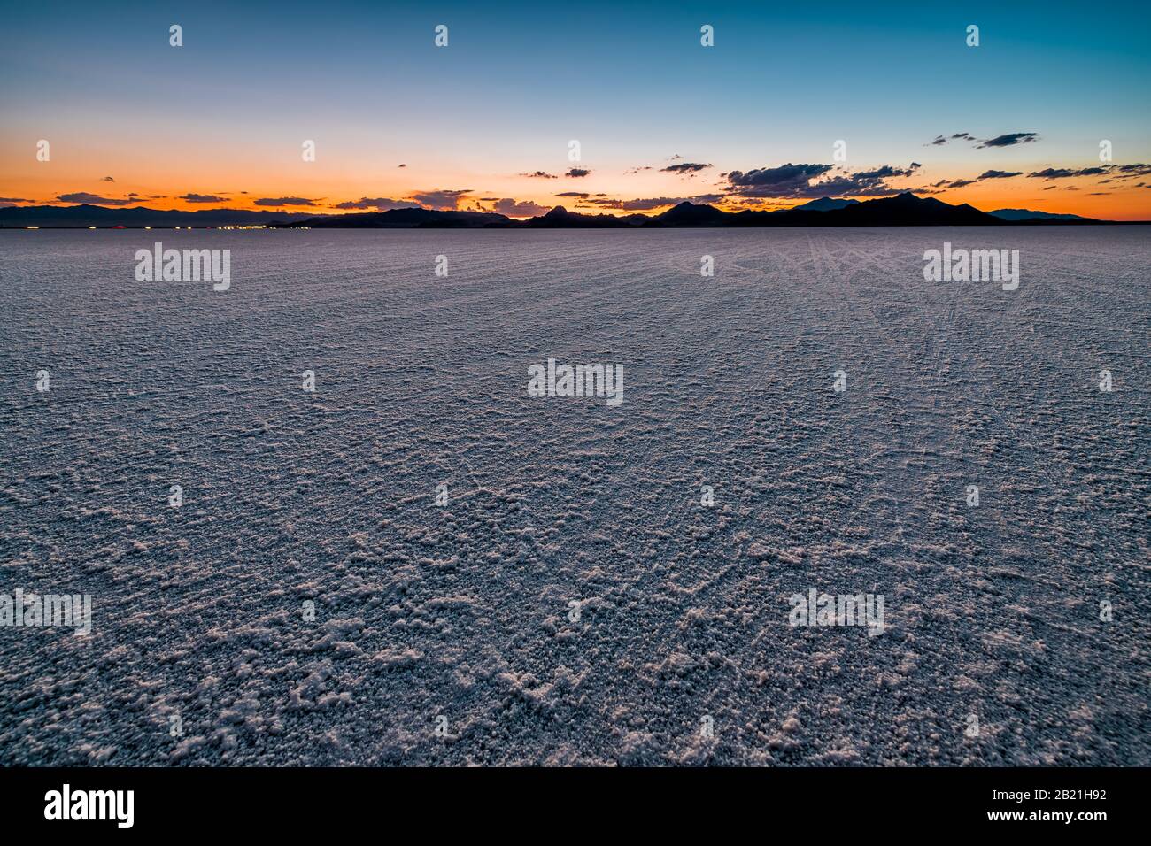 Bonneville Salt Flats landscape dark twilight sunset near Salt Lake City, Utah and silhouette view of mountains and cars on highway road Stock Photo