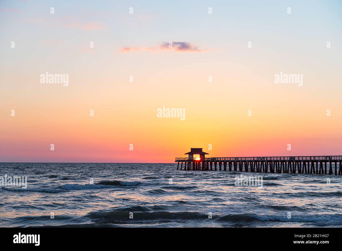 Naples, Florida vibrant red yellow sunset in gulf of Mexico with sun