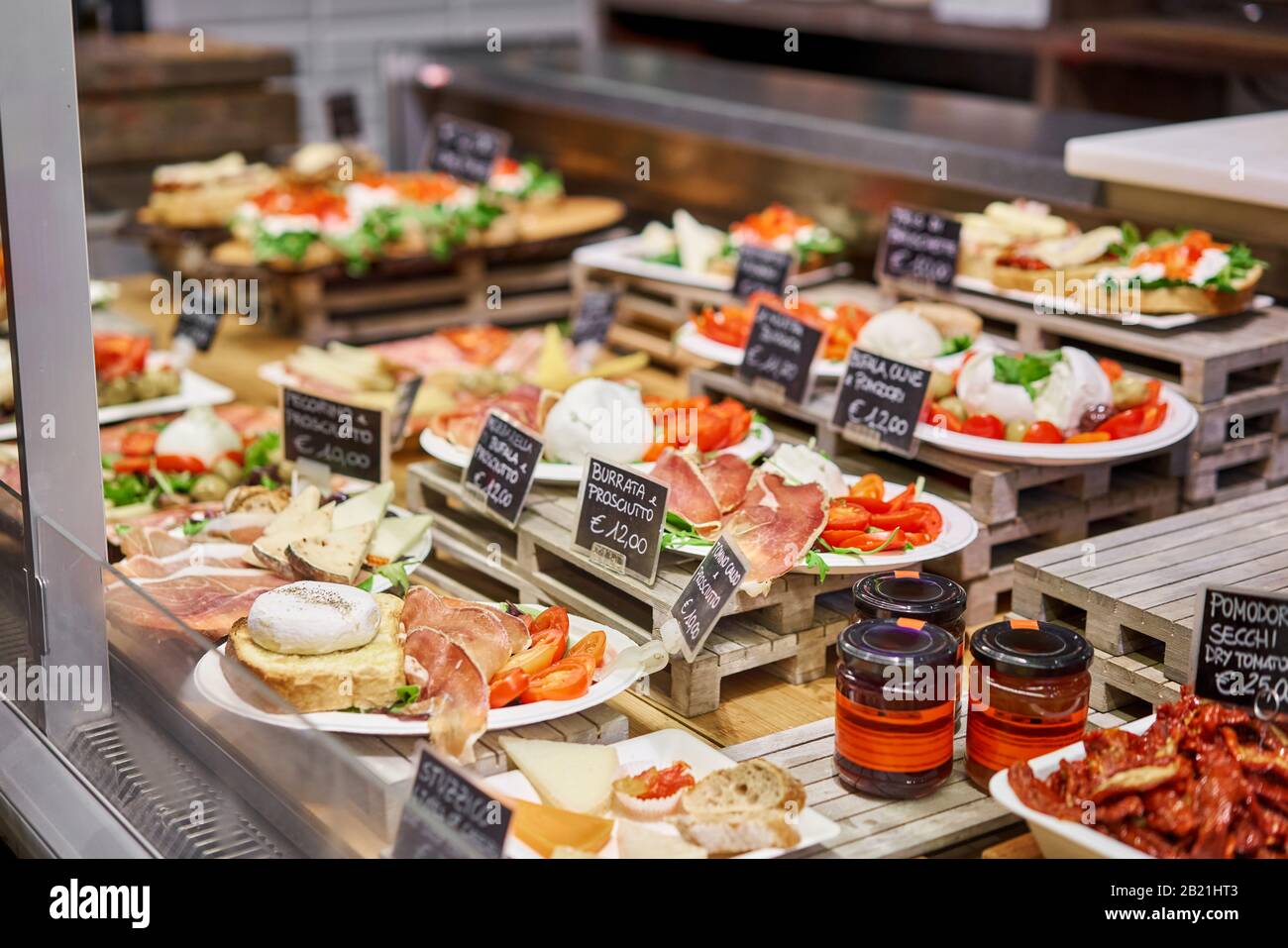 Various snacks and antipasti on the table of showcase. Street food