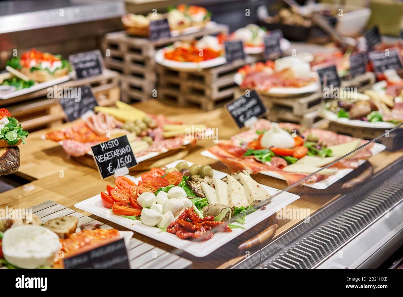 Various snacks and antipasti on the table of showcase. Street food