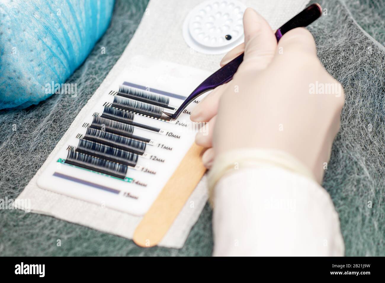 Master takes accessories and tools for eyelash extension Stock Photo