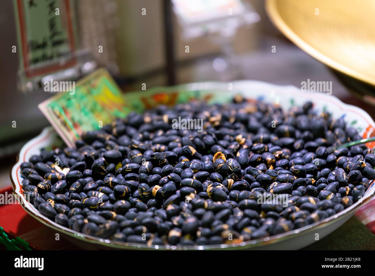 Kyoto, Japan macro closeup of many roasted black soy beans for sale