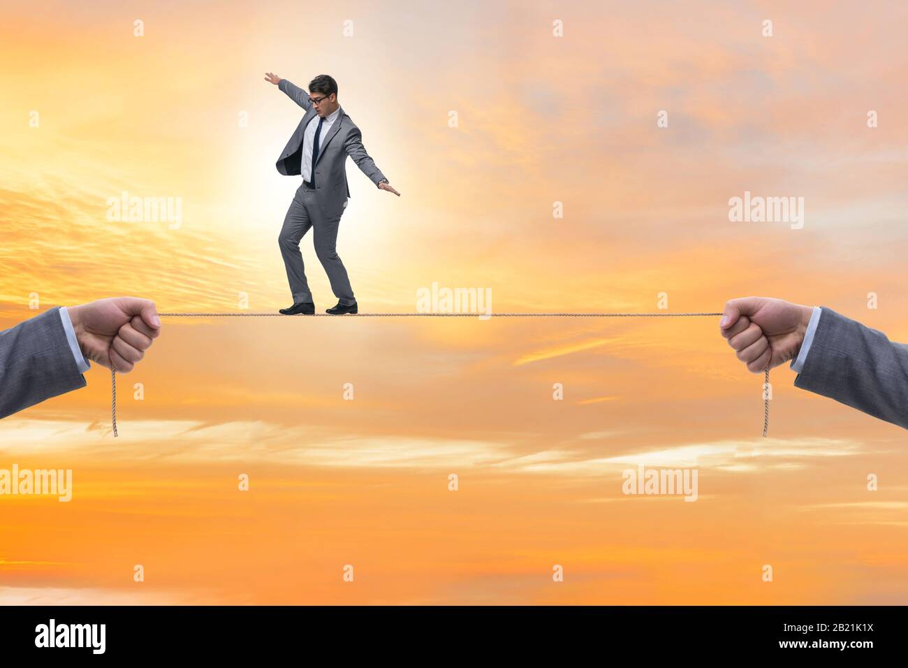 The businessman walking on tight rope Stock Photo Alamy