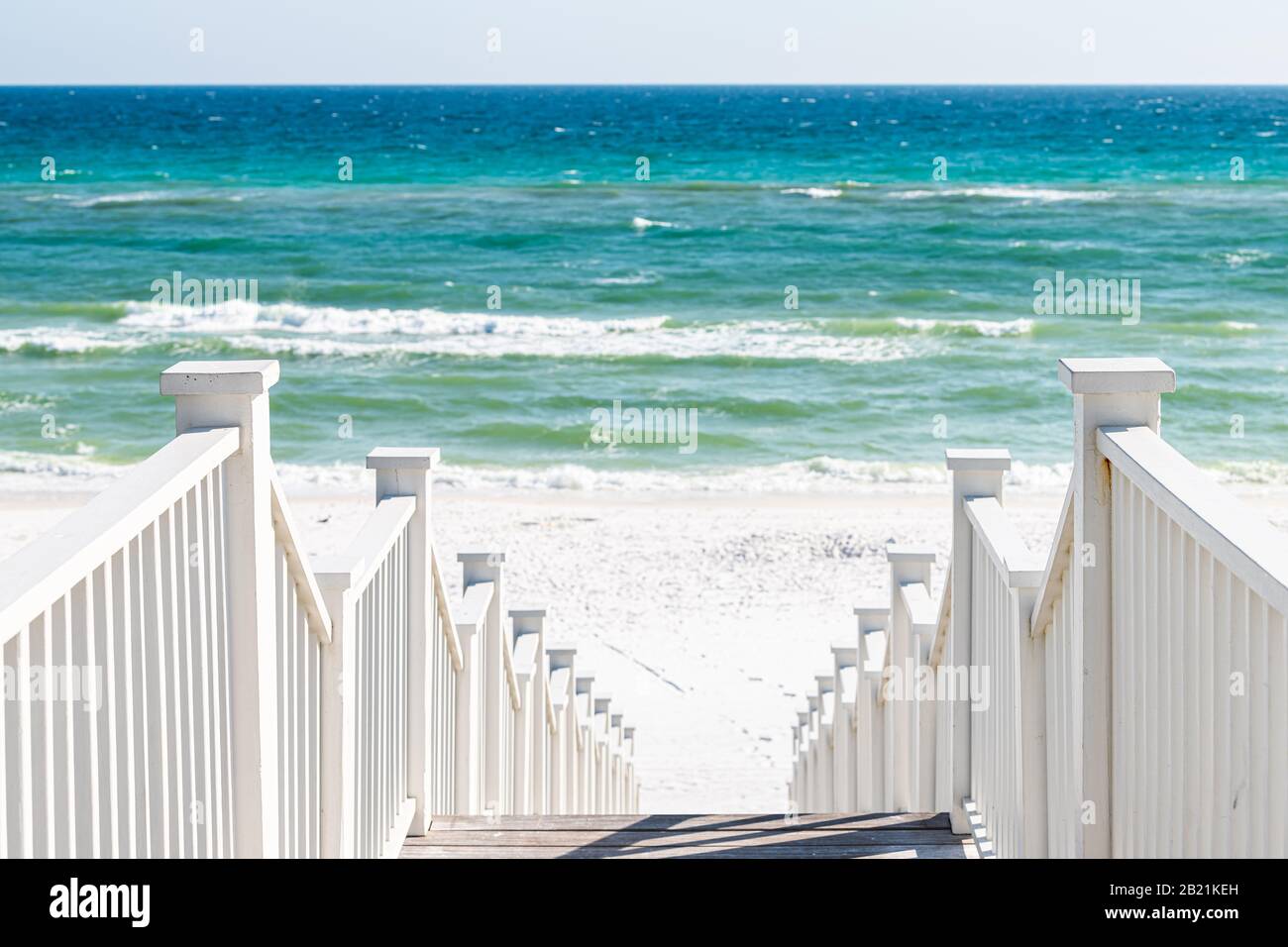 Seaside, Florida railing wooden stairway walkway steps architecture by beach ocean background view down during sunny day Stock Photo