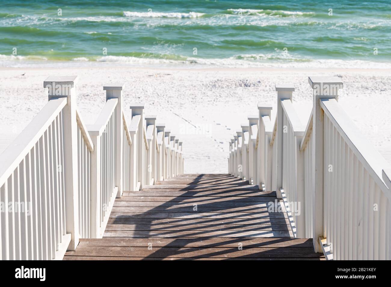 Seaside, Florida railing wooden pavilion walkway steps architecture by beach ocean background view down during sunny day Stock Photo