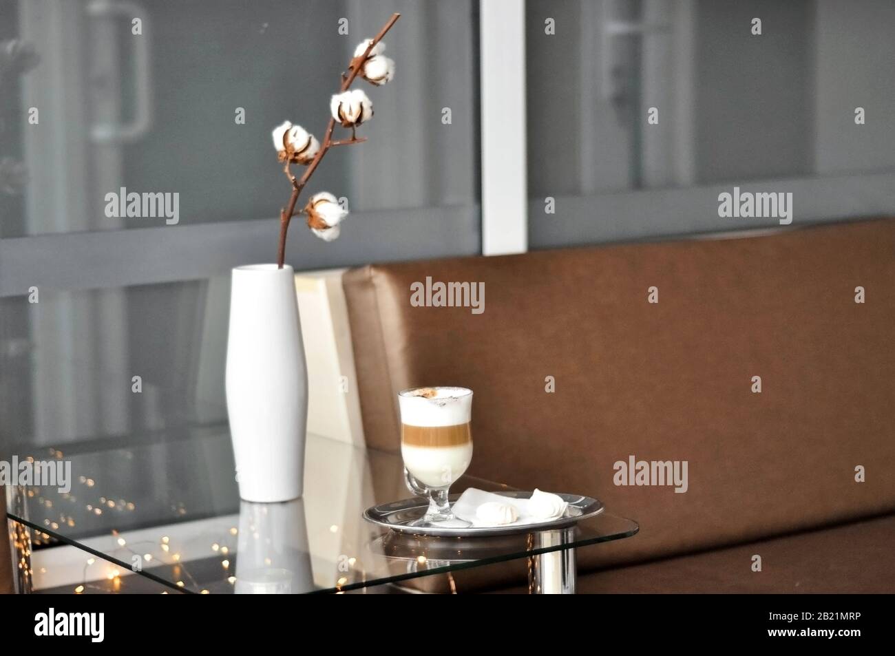 Waiting Area. Cozy customer reception area, lobby bar. A cup of coffee on the table near the sofa. Office waiting area Stock Photo