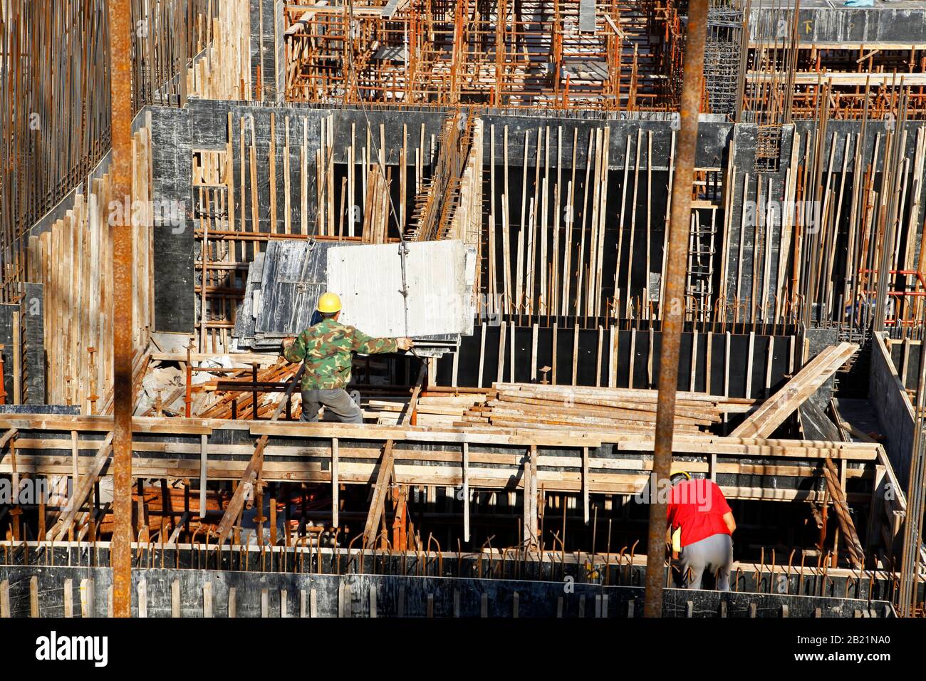 workers in the construction site making reinforcement metal framework ...