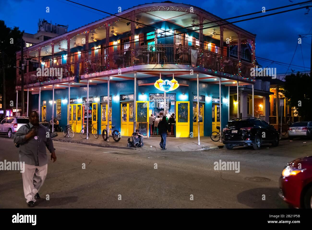 New Orleans, USA - April 22, 2018: Dat Dog food restaurant selling hot dogs with people sitting eating on street road at night evening blue hour Stock Photo